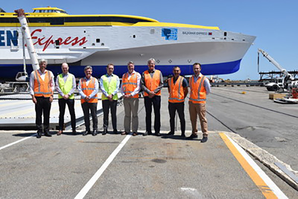 Darren Larkins and Simon Crook of SSI meet with Patrick Gregg, Gordon Blauw, Ben Wardle, and others from Austal in front of the 118m trimaran Bajamar Express. (CNW Group/SSI)